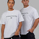 Man and Woman wearing Unisex 1% Better FLXCotton Tee Oversize - White